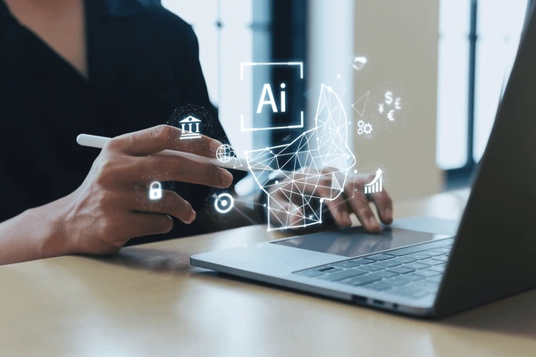 Marketer working on a laptop with AI marketing tools